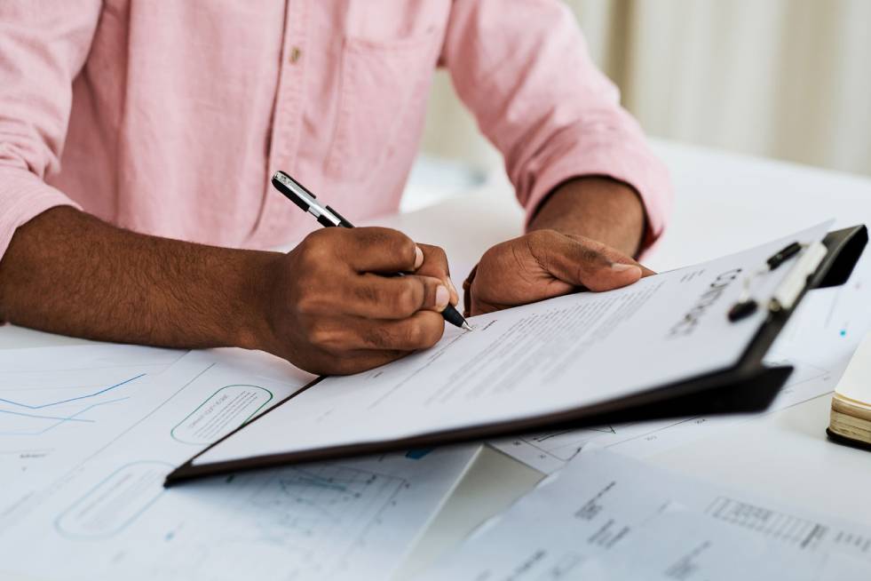 man signing insurance papers