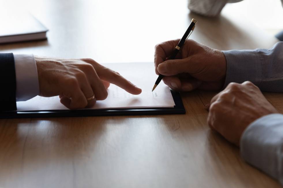 man signing insurance papers